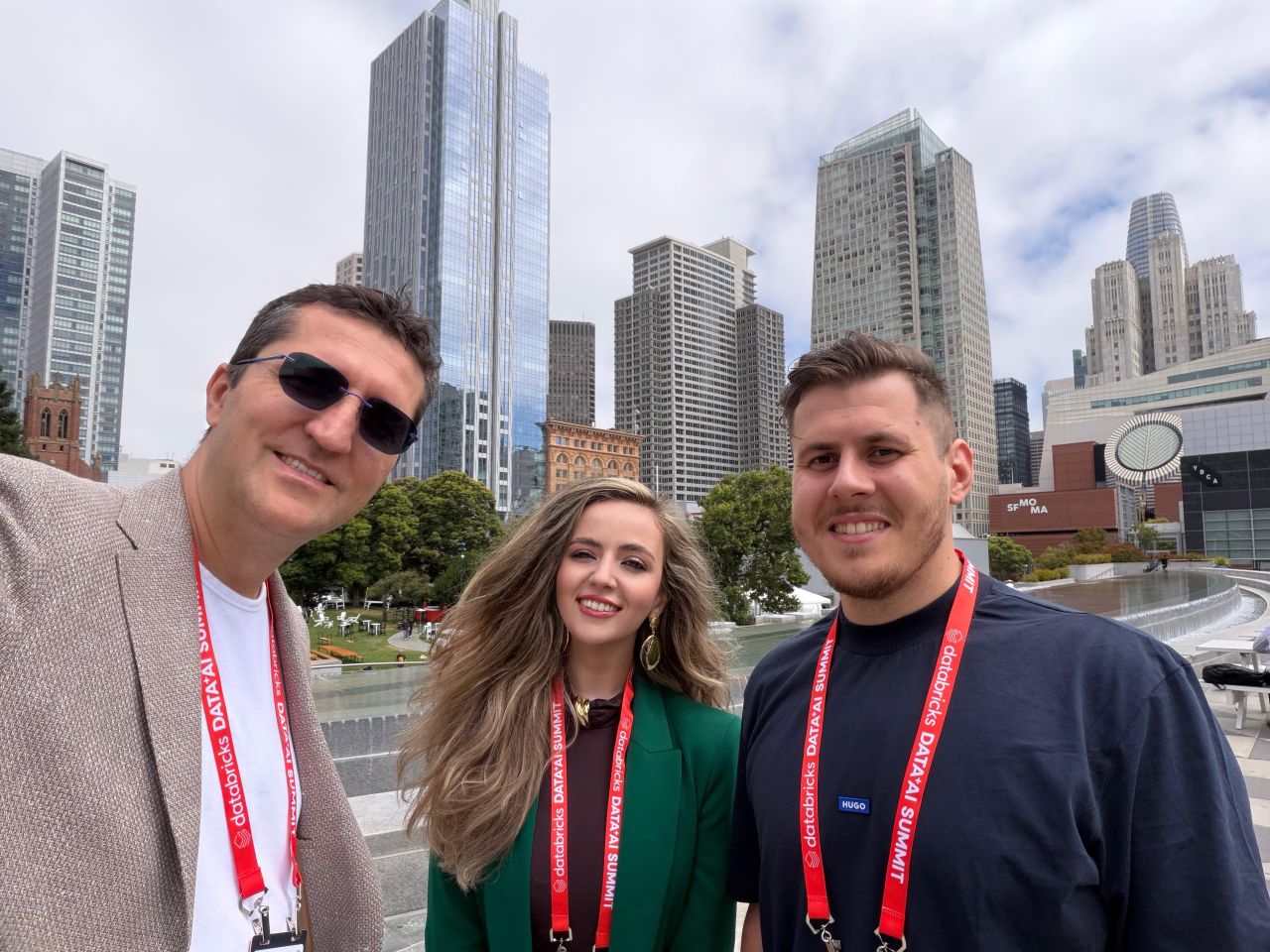 Laurentiu Amitroaie (mindit.io CINO), Roxana Staneiu (mindit.io Partnerships Director), and Alexandru Puiu (mindit.io CTO) at the Databricks Data & AI Summit 2026, in San Francisco